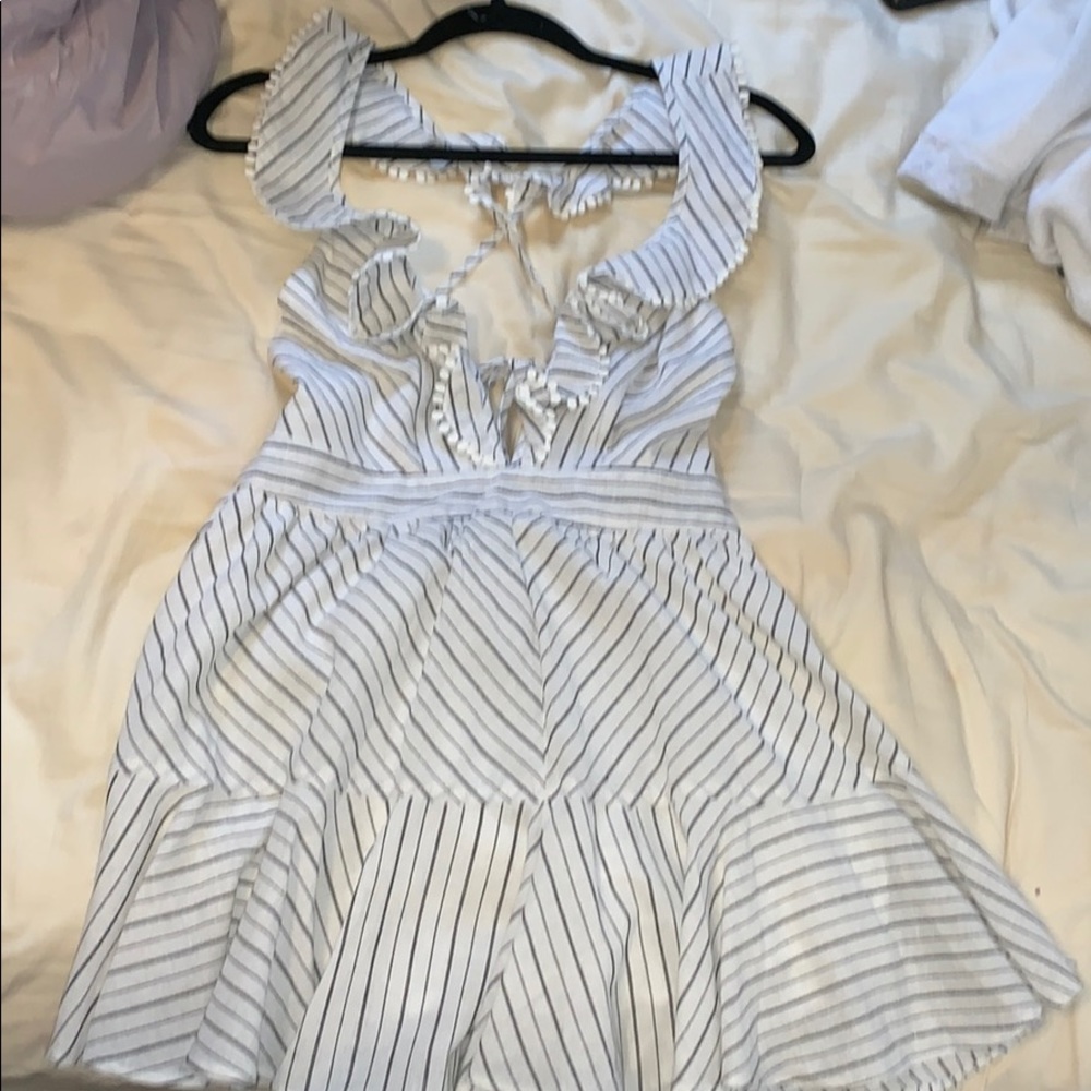 Brand new open back romper. Tags still on!